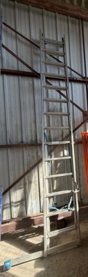 a man that is standing next to a ladder