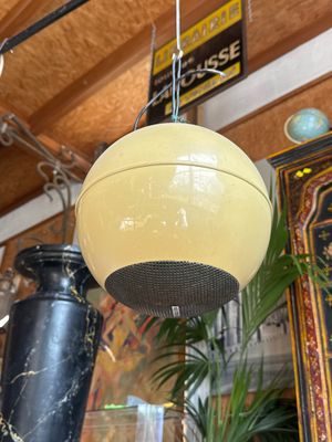 a yellow ball hanging from the ceiling in a room