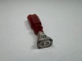 a small silver stamp with a red ribbon on it