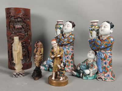five figurines of asian people sitting next to each other