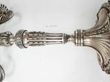 pair of antique silver plated candlesticks on a white background