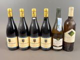 several bottles of wine are lined up on a table