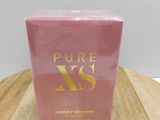 a pink box of perfume sitting on top of a wooden table