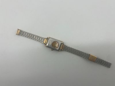 a close up of a wrist watch on a white surface