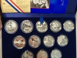 a person holding a box of silver coins with a picture of a man on it