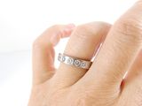 a woman ' s hand with a diamond ring on it