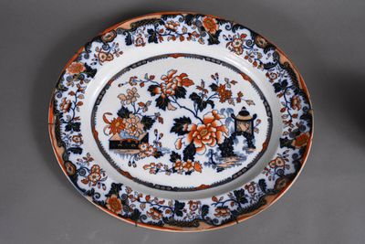 a plate with an orange and black floral design on it
