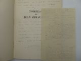 an open book sitting on top of a table next to a piece of paper