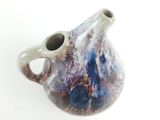 a blue and white vase with a hole in it