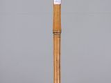 side view of a bamboo stick showing the wooden handle
