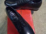 pair of black shoes on a red box on the floor