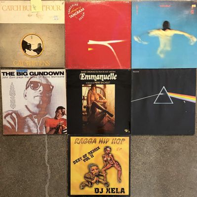 a lot of pink floyd album covers on the floor