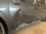 a car that has been wrapped in plastic and is parked in a garage