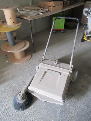a mop that is sitting on the floor in the garage