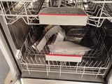 a dishwasher with a lot of dishes inside of it