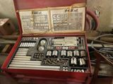 a red case with tools in it sitting on a table