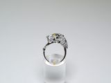 an image of a diamond ring on a clear glass stand