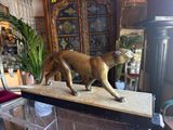 a statue of a lion on a table in a living room