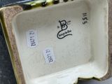 underside view of a porcelain bowl with writing on it