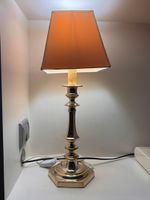 DEUX FLAMBEAUX à pans en bronze argenté montés en lampe.
