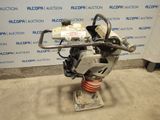 the engine of a car is sitting on a stand in front of a wall