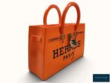 an orange hermes paris bag with two handles on a white background
