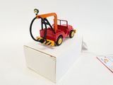 a red toy truck with a light on top of it
