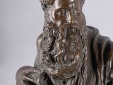statue of a man with a beard and a book in his lap