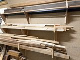 many pieces of wood stacked on a shelf in a room