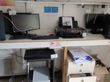 a desk with a lot of computer equipment on top of it