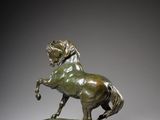 an image of a bronze statue of a horse on a marble base