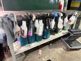 many bottles of cleaning products on a shelf in a garage