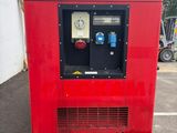 a red machine that is sitting in a parking lot