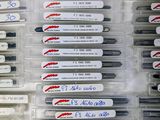 a lot of pens that are sitting in a box