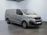 a grey van is parked in a large room with a white wall
