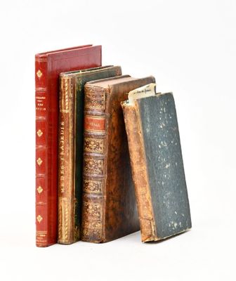 plusieurs vieux livres sont empilés sur une surface blanche