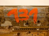 an orange number painted on the side of a door