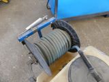an image of a hose being hooked to a reel
