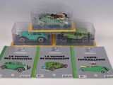 three green toy cars are sitting in a display case on a white surface