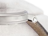 a close up of a watch on a white cloth