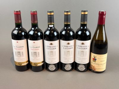several bottles of wine are lined up on a table