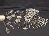 a lot of silver spoons and spoons on a black background