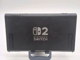 a nintendo switch on a stand on a white surface