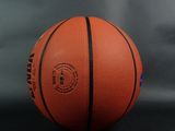 an orange basketball ball sitting on top of a black surface