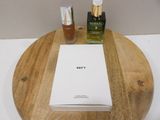 two bottles of perfume and a box on a wooden tray