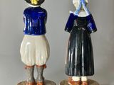 pair of ceramic figurines of a woman and a man dressed in colonial clothing
