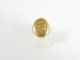a close up of a gold ring on a white surface