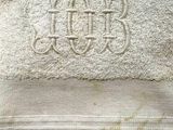 towel with a monogram on it sitting on top of a bed