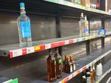 many empty bottles of alcohol on the shelves in the store