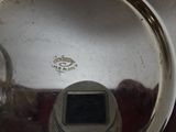 a close up view of a silver plate with a digital device in it